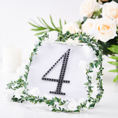 Table number 4 with floral accents and greenery decoration.
