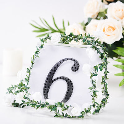Table number 6 with floral decoration on a white background.