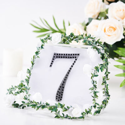 Table number 7 with floral decoration and greenery accents.