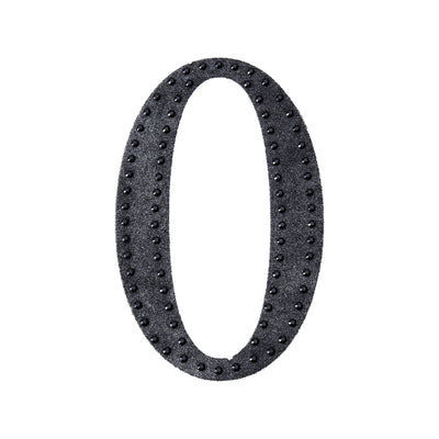 Black decorative number zero with studded design on a white background