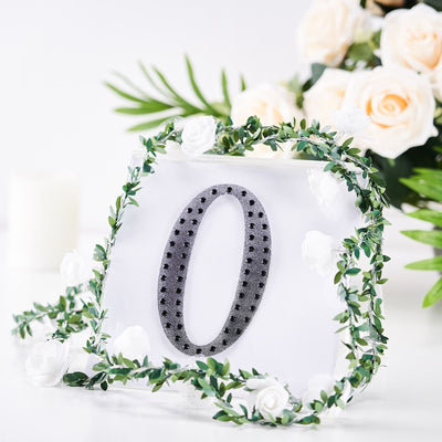 Decorative number zero with greenery and flowers, perfect for celebrations.