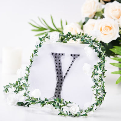 Decorative letter "Y" with floral accents on a white background.