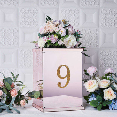 Pink mirrored floral display box with gold number 9 and assorted flowers.