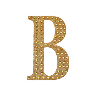 Gold studded letter B on white background