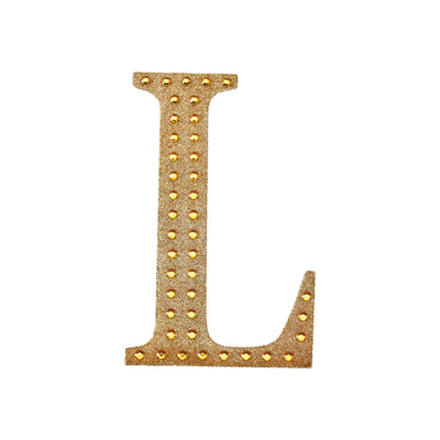 Gold rhinestone letter "L" on a white background.