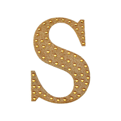 Gold studded letter S on a white background