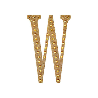 Gold glitter letter "W" with rhinestones on a white background