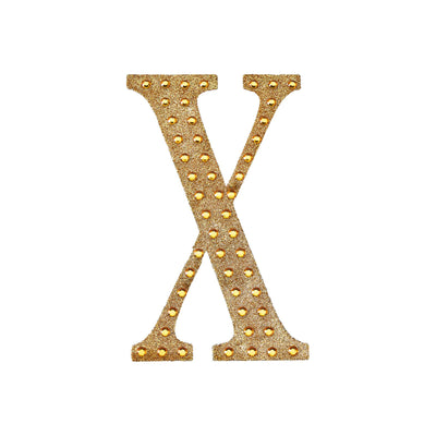Gold glitter letter X with rhinestones on a white background