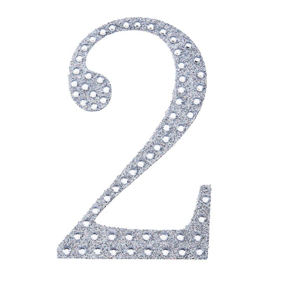 Glittery silver number two cutout on a white background