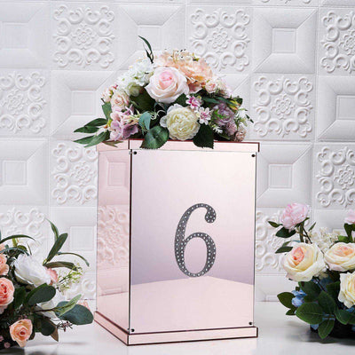 Rose gold table number stand with floral arrangement, featuring the number 6.