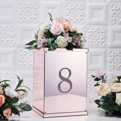 Rose gold floral arrangement box with number 8, surrounded by pink and white flowers.