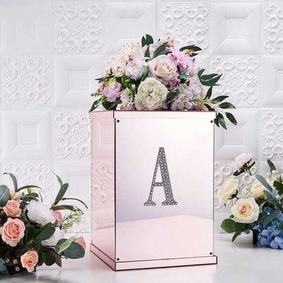 Decorative rose gold box with floral arrangement and letter "A" design.