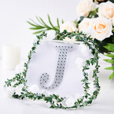 Silver rhinestone initial "J" handbag with floral accents.