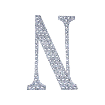 Silver glitter letter "N" cutout on a white background.