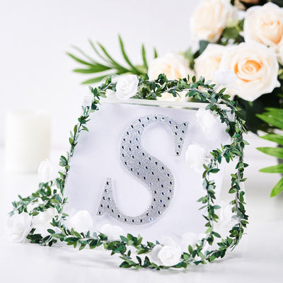 Personalized clear acrylic letter "S" with rhinestones and floral decoration.