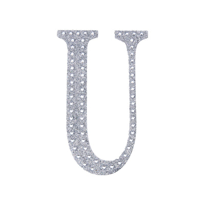 Glittery silver letter "U" cutout on a white background