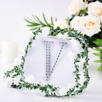 Decorative letter "V" with floral accents on a white background.