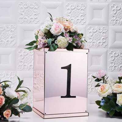 Rose gold number one display box with flowers on a textured background.