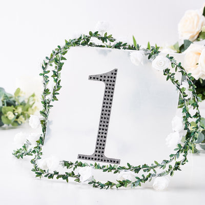 Decorative table number "1" with floral frame on a white background.