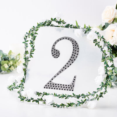 Table number 2 sign with floral decoration on a white background