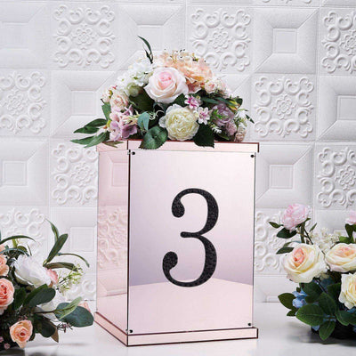 Mirrored flower box with number 3 and floral arrangement on a textured background.