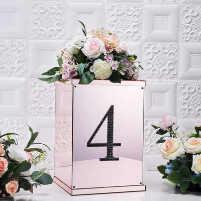 Rose gold table number holder with floral arrangement, featuring the number 4.