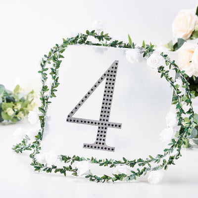 Decorative table number 4 with rhinestones and floral greenery