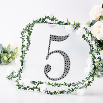Table number 5 with floral decoration on a clear backdrop