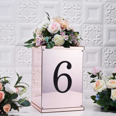 Rose gold floral arrangement box with number 6 and decorative flowers.