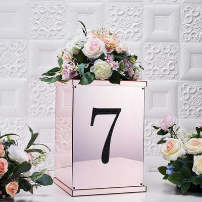Rose gold table number holder with flowers, featuring the number 7.