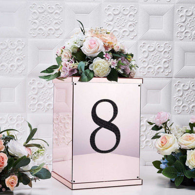 Rose gold floral display stand with number 8 and decorative flowers.