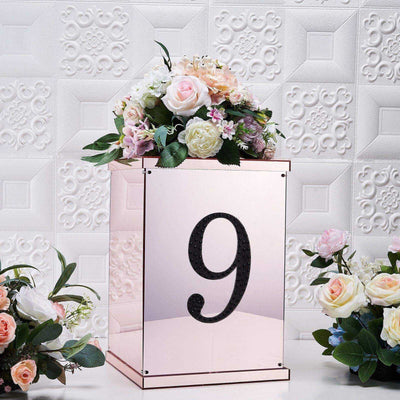Rose gold table number holder with flowers, number 9 displayed.