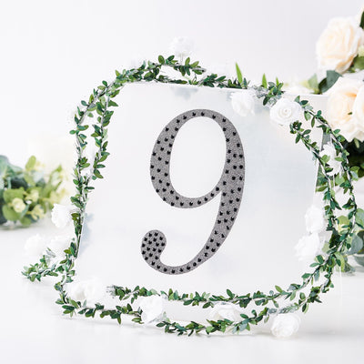 Table number sign with floral decor, featuring the number nine in a stylish design.