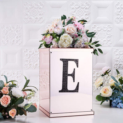 Elegant floral arrangement on a mirrored box with the letter "E".