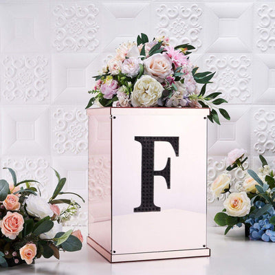 Elegant floral arrangement in a rose gold box with a black letter "F".