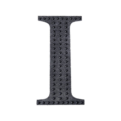Black textured letter "I" with studs on a plain white background