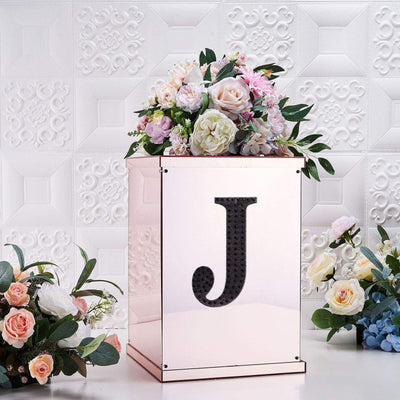 Rose gold floral display box with letter "J", adorned with fresh flowers.