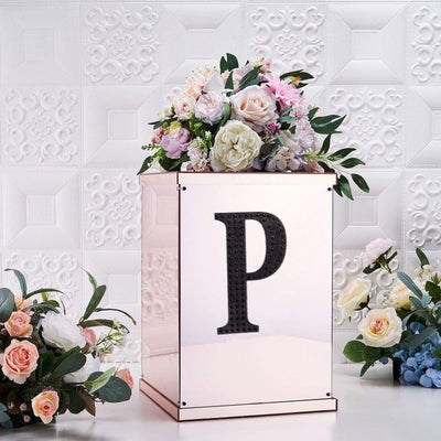 Elegant floral arrangement on a decorative box with a letter "P".