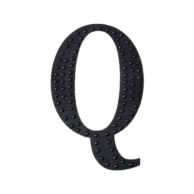 Black fabric letter "Q" adorned with rhinestones
