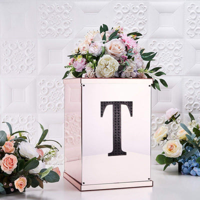 Decorative floral arrangement on a rose gold box with a letter "T" design.