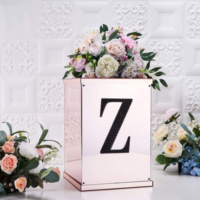 Rose gold floral arrangement box with letter "Z" on a decorative background.