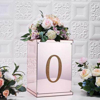 Pink mirrored box with floral arrangement and number "0" on a decorative background.