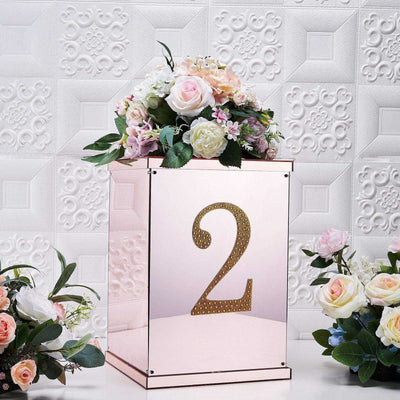 Decorative rose gold table number holder with flowers, number 2 displayed.