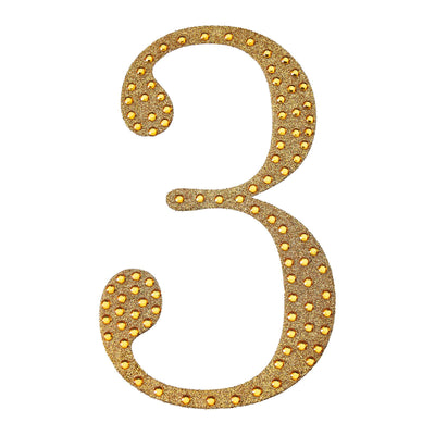 Gold glitter number three with lights on a plain background