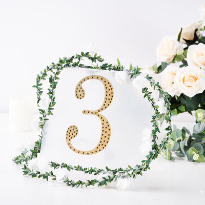 Table number three with gold detailing and floral accents