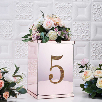 Elegant mirrored table number holder with floral arrangement and number 5.