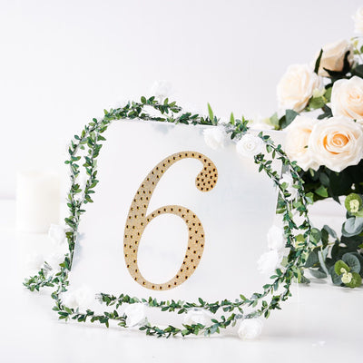 Table number six with golden embellishments and floral accents