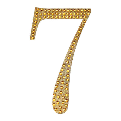 Gold studded number 7 cutout on a white background.