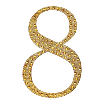 Gold glitter number 8 with lights on a plain background