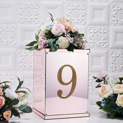 Rose gold table number display with floral arrangement, number 9.